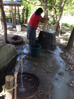 Los Hatillos Woman Washing At Faucet.JPG