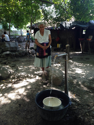 Los Hatillos Woman At Faucet.JPG